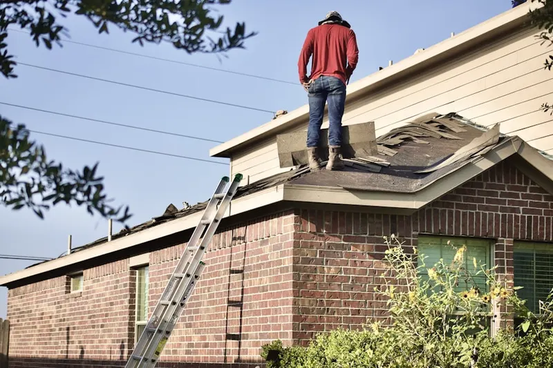 Professional roofer working on a residential roof in Greenfield Summit